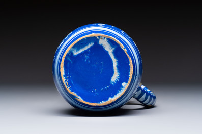 A Nevers white-decorated Persian-blue-ground faience jug with a mounted pewter lid, France, 18th C.