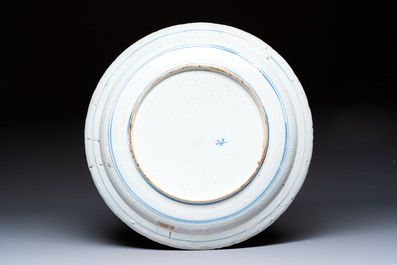 A large blue and white Dutch Delft armorial dish, 18th C.