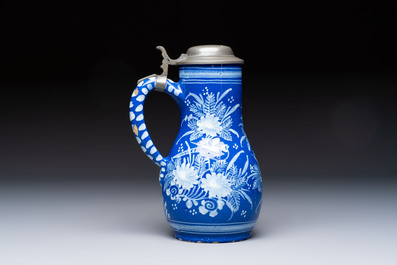 A Nevers white-decorated Persian-blue-ground faience jug with a mounted pewter lid, France, 18th C.