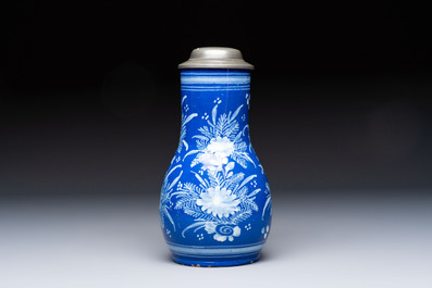 A Nevers white-decorated Persian-blue-ground faience jug with a mounted pewter lid, France, 18th C.