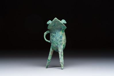 A Chinese archaic bronze wine vessel with Taotie design, Jue 爵, late Shang