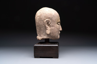 A Chinese sandstone head of a Luohan, early Qing