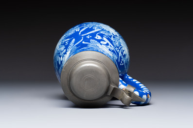 A Nevers white-decorated Persian-blue-ground faience jug with a mounted pewter lid, France, 18th C.