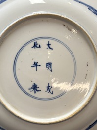 A Chinese blue and white dish and two Imari-style plates with figural design, Chenghua mark, Kangxi/Yongzheng