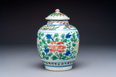 A Chinese wucai &lsquo;Buddhist Lion&rsquo; vase and cover, Transitional period