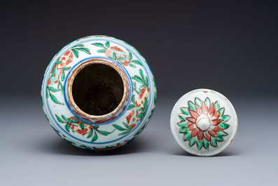 A Chinese wucai &lsquo;Buddhist Lion&rsquo; vase and cover, Transitional period