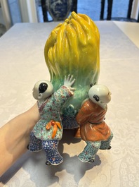 A Chinese famille rose figure of three boys holding a Buddha&rsquo;s hand, Republic