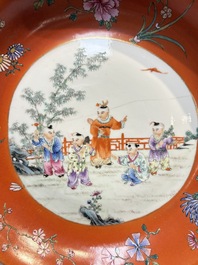 A pair of Chinese famille rose coral-ground 'Playing Boys' plates, Jiaqing marks, Republic