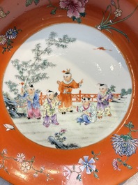 A pair of Chinese famille rose coral-ground 'Playing Boys' plates, Jiaqing marks, Republic