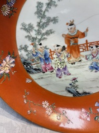 A pair of Chinese famille rose coral-ground 'Playing Boys' plates, Jiaqing marks, Republic