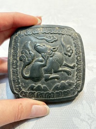 A Chinese carved black pottery 'Mythical Animal' box and cover, Yuan/Ming
