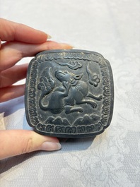 A Chinese carved black pottery 'Mythical Animal' box and cover, Yuan/Ming