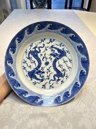 A pair of Chinese blue and white 'Dragon' dishes, Chenghua mark, Kangxi