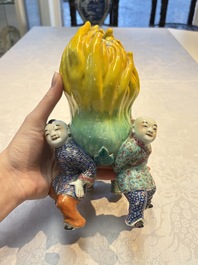 A Chinese famille rose figure of three boys holding a Buddha&rsquo;s hand, Republic