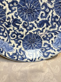 A large Chinese blue and white 'Lotus Scroll' dish, Kangxi