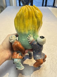 A Chinese famille rose figure of three boys holding a Buddha&rsquo;s hand, Republic