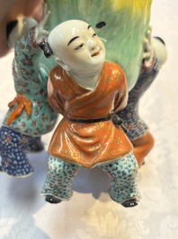 A Chinese famille rose figure of three boys holding a Buddha&rsquo;s hand, Republic