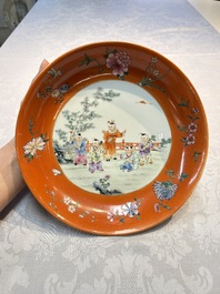A pair of Chinese famille rose coral-ground 'Playing Boys' plates, Jiaqing marks, Republic
