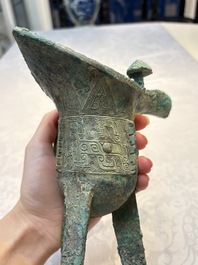 A Chinese archaic bronze wine vessel with Taotie design, Jue 爵, late Shang