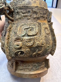 A Chinese archaic bronze wine vessel and cover with Taotie design, You 卣, late Shang