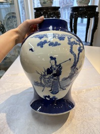 A Chinese blue and white powder-blue-ground 'He Xiangu 何仙姑' vase and cover, 19th C.