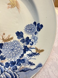 A large Chinese blue and white gilt-decorated dish with birds and insects among bamboo and peonies, Yongzheng