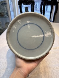 A Chinese blue and white powder-blue-ground 'He Xiangu 何仙姑' vase and cover, 19th C.