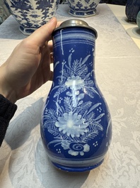 A Nevers white-decorated Persian-blue-ground faience jug with a mounted pewter lid, France, 18th C.