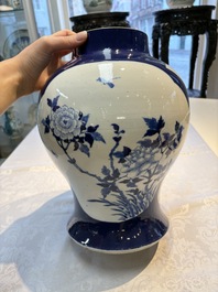 A Chinese blue and white powder-blue-ground 'He Xiangu 何仙姑' vase and cover, 19th C.