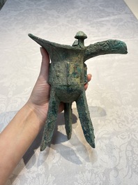 A Chinese archaic bronze wine vessel with Taotie design, Jue 爵, late Shang