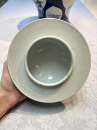 A Chinese blue and white powder-blue-ground 'He Xiangu 何仙姑' vase and cover, 19th C.