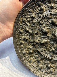 Two Chinese bronze mirrors, one inscribed &lsquo;Fu Shan Shou Hai 福山壽海' and the other with sea animals and grape design, Qing