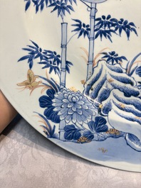 A large Chinese blue and white gilt-decorated dish with birds and insects among bamboo and peonies, Yongzheng