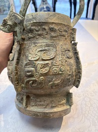 A Chinese archaic bronze wine vessel and cover with Taotie design, You 卣, late Shang