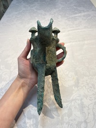 A Chinese archaic bronze wine vessel with Taotie design, Jue 爵, late Shang