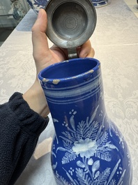 A Nevers white-decorated Persian-blue-ground faience jug with a mounted pewter lid, France, 18th C.