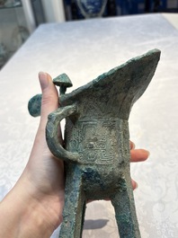 A Chinese archaic bronze wine vessel with Taotie design, Jue 爵, late Shang