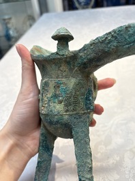 A Chinese archaic bronze wine vessel with Taotie design, Jue 爵, late Shang