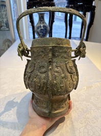 A Chinese archaic bronze wine vessel and cover with Taotie design, You 卣, late Shang