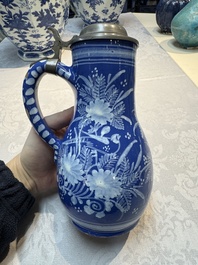 A Nevers white-decorated Persian-blue-ground faience jug with a mounted pewter lid, France, 18th C.