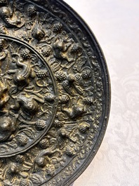 Two Chinese bronze mirrors, one inscribed &lsquo;Fu Shan Shou Hai 福山壽海' and the other with sea animals and grape design, Qing
