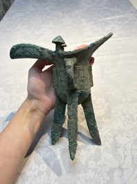 A Chinese archaic bronze wine vessel with Taotie design, Jue 爵, late Shang