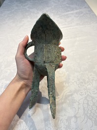 A Chinese archaic bronze wine vessel with Taotie design, Jue 爵, late Shang