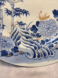 A large Chinese blue and white gilt-decorated dish with birds and insects among bamboo and peonies, Yongzheng