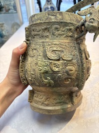 A Chinese archaic bronze wine vessel and cover with Taotie design, You 卣, late Shang