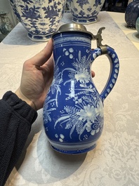 A Nevers white-decorated Persian-blue-ground faience jug with a mounted pewter lid, France, 18th C.