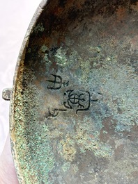A Chinese archaic bronze wine vessel and cover with Taotie design, You 卣, late Shang