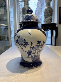 A Chinese blue and white powder-blue-ground 'He Xiangu 何仙姑' vase and cover, 19th C.