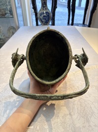 A Chinese archaic bronze wine vessel and cover with Taotie design, You 卣, late Shang
