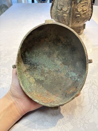 A Chinese archaic bronze wine vessel and cover with Taotie design, You 卣, late Shang